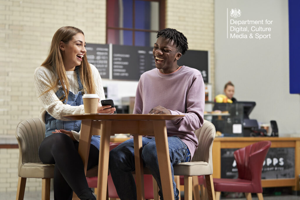 Two casual dressed young women drinking coffees and smoothies, using a laptop in the coffee shop. Multi-location photography