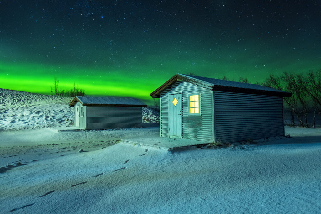 Small house in Iceland with Aurora Borealis. Multi-location brand photography