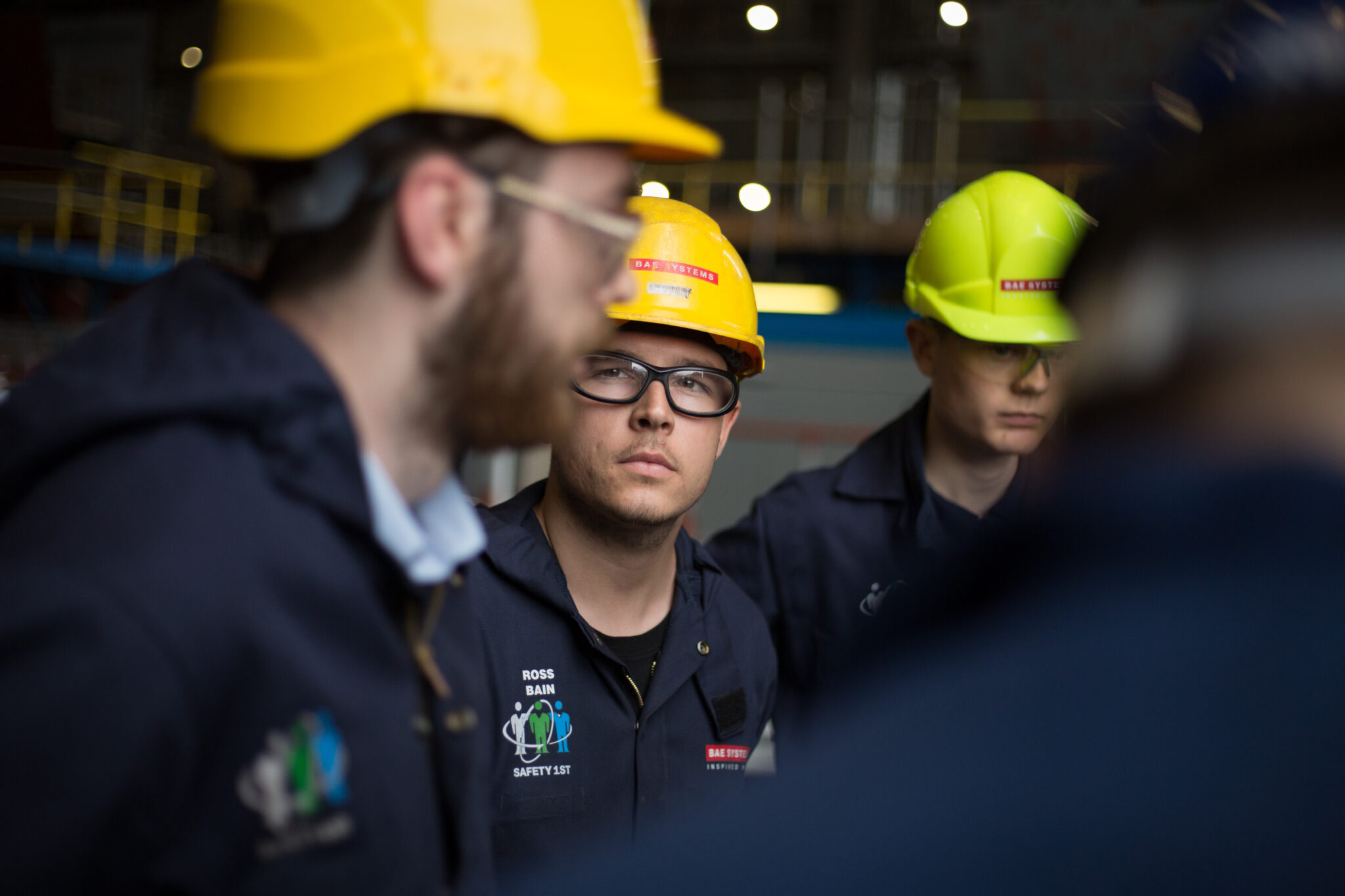 Apprentices, left to right: Patrick Carins, Ross Brian (centre, in glasses), Jack Turnbull - The building of 1st-in-class Type 26 Global Combat Ship, the HMS Glasgow, at BAE Systems Govan, in Glasgow, Scotland, Employee brand visual library photography