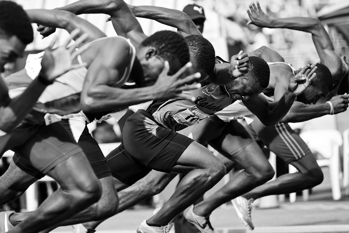 A group of men running on the track. Campaign Photography