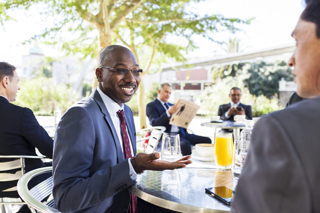 Commercial Brand Photography. A man in a suit and tie holding a glass of wine.